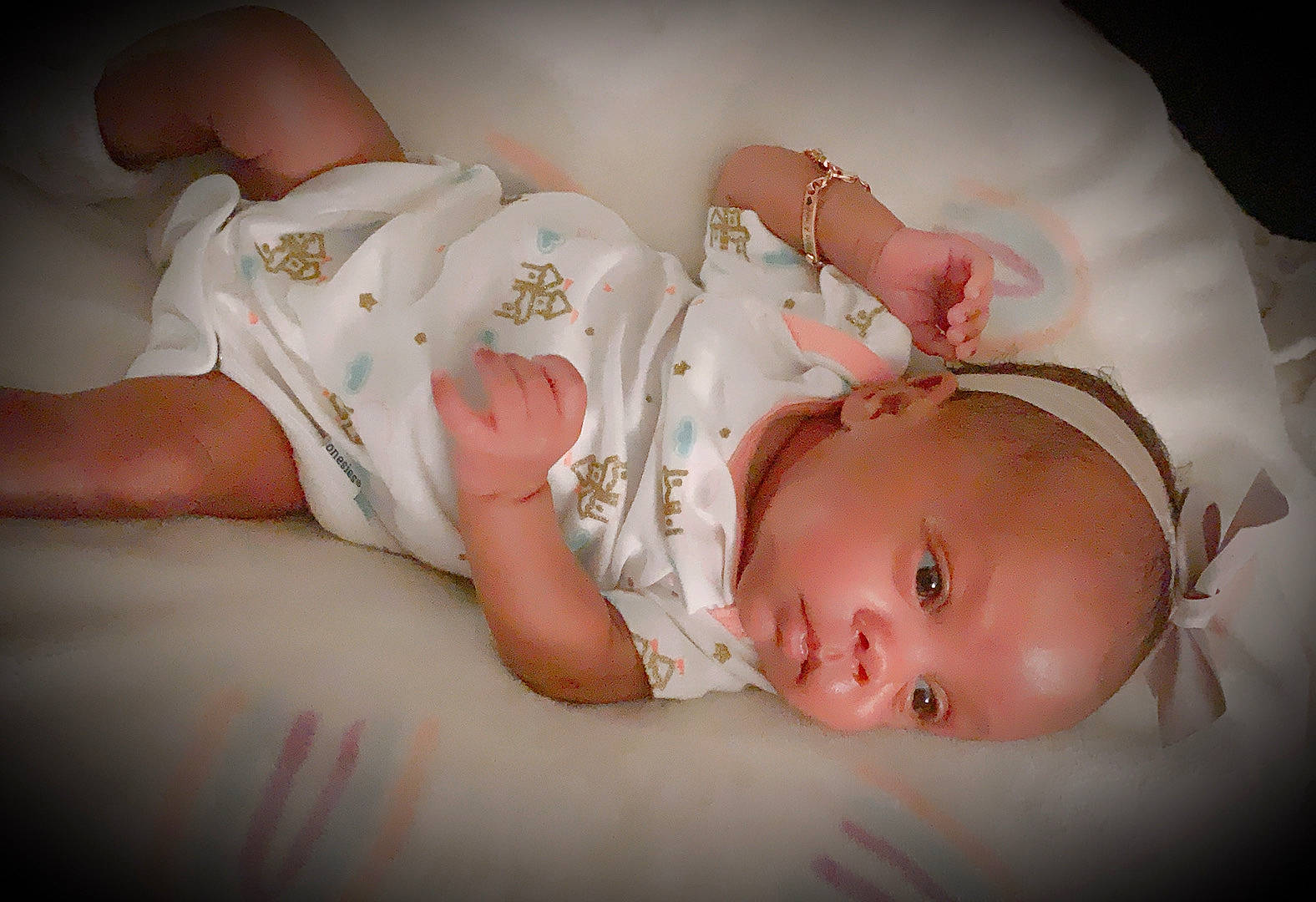 Halo is registered to the contest to win money with this photo: baby, baby_products, baby_toddler_clothing, cheek, child, comfort, dress, flash_photography, hair_accessory, headgear, human_body, human_leg, mouth, pattern, person, pink, product, room, skin, stomach