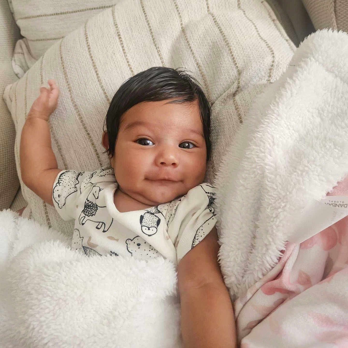 Kency joined the competition — help win amazing prizes! animal_print, arm, baby, black_hair, blanket, child, cozy, cute, face, happy, indoor, infant, lying_down, onesie, pillow, portrait, resting, skin, smile, soft_texture