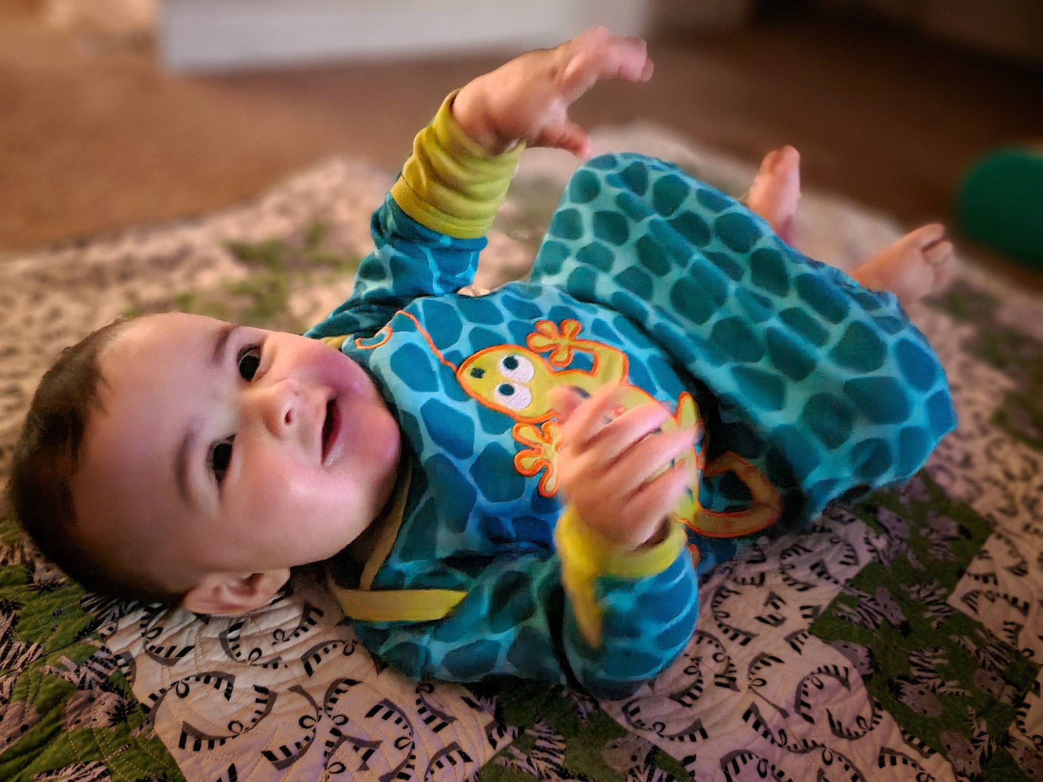 Zaidan is registered to the contest to win money with this photo: baby, baby_products, baby_toddler_clothing, cheek, child, comfort, flooring, foot, fun, grass, green, happy, pattern, person, sitting, skin, sleeve, smile, textile, toddler
