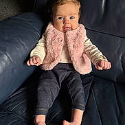 Charlotte joined the competition — help win amazing prizes! baby, blue_eyes, child, couch, cute, denim_pants, expression_tongue, face, fluffy_clothing, hands, home, indoor, infant, leather_sofa, photography, pink_vest, portrait, sitting, smile, toes