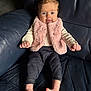 baby, blue_eyes, child, couch, cute, denim_pants, expression_tongue, face, fluffy_clothing, hands, home, indoor, infant, leather_sofa, photography, pink_vest, portrait, sitting, smile, toes