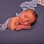 newborn, baby, sleeping, blue_blanket, knitted_wrap, soft_texture, peaceful, infant, portrait, closeup, skin, resting, cute, child, indoors, cozy, relaxation, small_hands, face, head