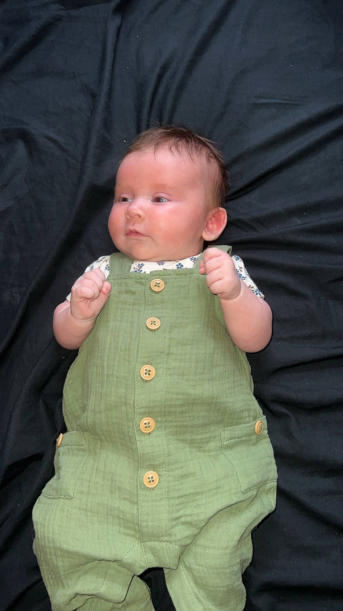 Olive is registered to the contest to win money with this photo: arm, baby, baby_toddler_clothing, cheek, chin, eye, eyebrow, face, facial_expression, gesture, hair, hand, head, human_body, iris, lip, neck, nose, person, skin