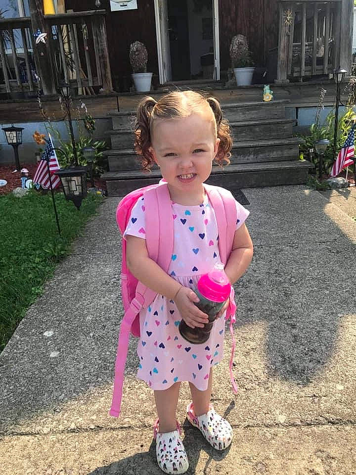 Amora is registered to the contest to win money with this photo: baby_toddler_clothing, child, fun, grass, happy, human_settlement, joy, leaf, leisure, magenta, pattern, person, pink, plant, public_space, road_surface, sandal, sidewalk, smile, spring