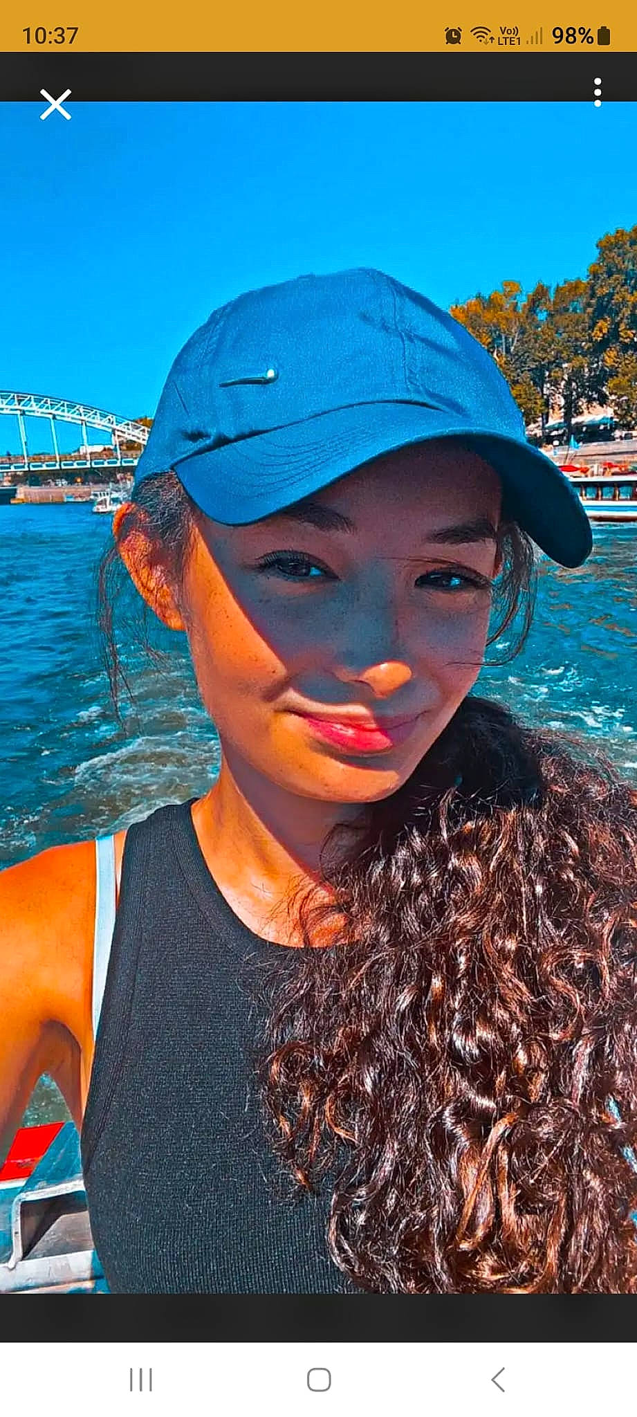 Savannah participe au concours pour gagner de l'argent avec cette photo : baseball_cap, black_hair, blue, cap, chin, cool, flash_photography, fun, happy, hat, headgear, headwear, lake, leisure, lip, person, sky, smile, summer, travel