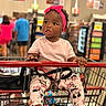 toddler, child, shopping_cart, grocery_store, pink_headband, leggings, minnie_mouse, tongue_out, cute, baby, shopping, retail, people, blurred_background, footwear, bag, clothing, indoor, person, playful