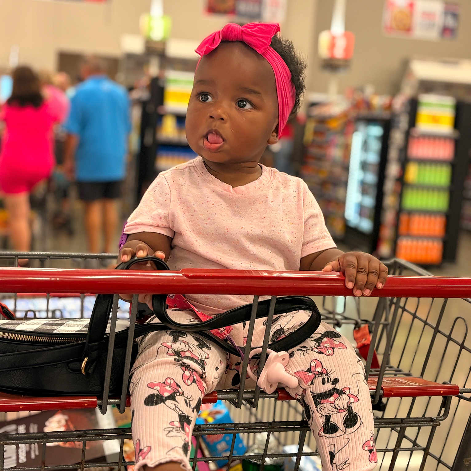 Love joined the competition — help win amazing prizes! toddler, child, shopping_cart, grocery_store, pink_headband, leggings, minnie_mouse, tongue_out, cute, baby, shopping, retail, people, blurred_background, footwear, bag, clothing, indoor, person, playful