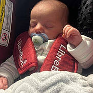 Elsie joined the competition — help win amazing prizes! baby, sleeping, pacifier, car_seat, red, blanket, infant, child, clothing, face, hand, cozy, comfort, rest, young, cute, indoors, seatbelt, soft, peaceful