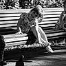 child, girl, bench, pigeon, smile, outdoor, sunlight, shadow, dress, playful, park, person, happy, sitting, nature, trees, footwear, black_and_white, photography, portrait