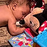 Brianna joined the competition — help win amazing prizes! baby, sleeping, plush_toy, minnie_mouse, carpet, toy, soft_book, unicorn, colorful, child, cute, nap, indoor, floor, arm, head, curly_hair, pattern, red, blue