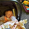 Brianna is registered to the contest to win money with this photo: baby, bottle, car_seat, blanket, toy, floor, carpet, sleeping, infant, child, indoor, clothing, hand, footwear, colorful, plastic, soft, cute, peaceful, resting