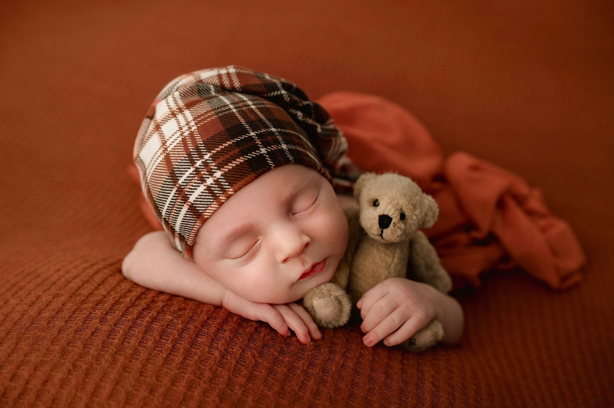 Leland joined the competition — help win amazing prizes! baby, baby_toddler_clothing, cap, child, comfort, companion_dog, doll, flooring, headwear, knit_cap, linens, nail, pattern, person, plaid, sitting, skin, sleeve, tartan, toddler
