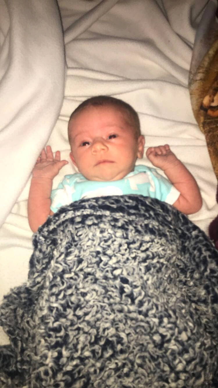 River is registered to the contest to win money with this photo: baby, baby_toddler_clothing, beauty, cheek, child, comfort, facial_expression, finger, hairstyle, human, linens, mammal, nose, organ, pattern, person, product, skin, sleeve, textile