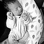newborn, baby, sleeping, pajamas, cushion, leaf_pattern, infant, cozy, resting, indoor, black_and_white, person, small_hands, soft, peaceful, cute, head, fingers, feet, fabric