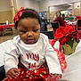 baby, child, tutu, red_bow, curly_hair, white_shirt, holiday, poinsettia, indoor, table, chair, people, celebration, festive_clothing, person, cute, party, decor, tablecloth, toddler
