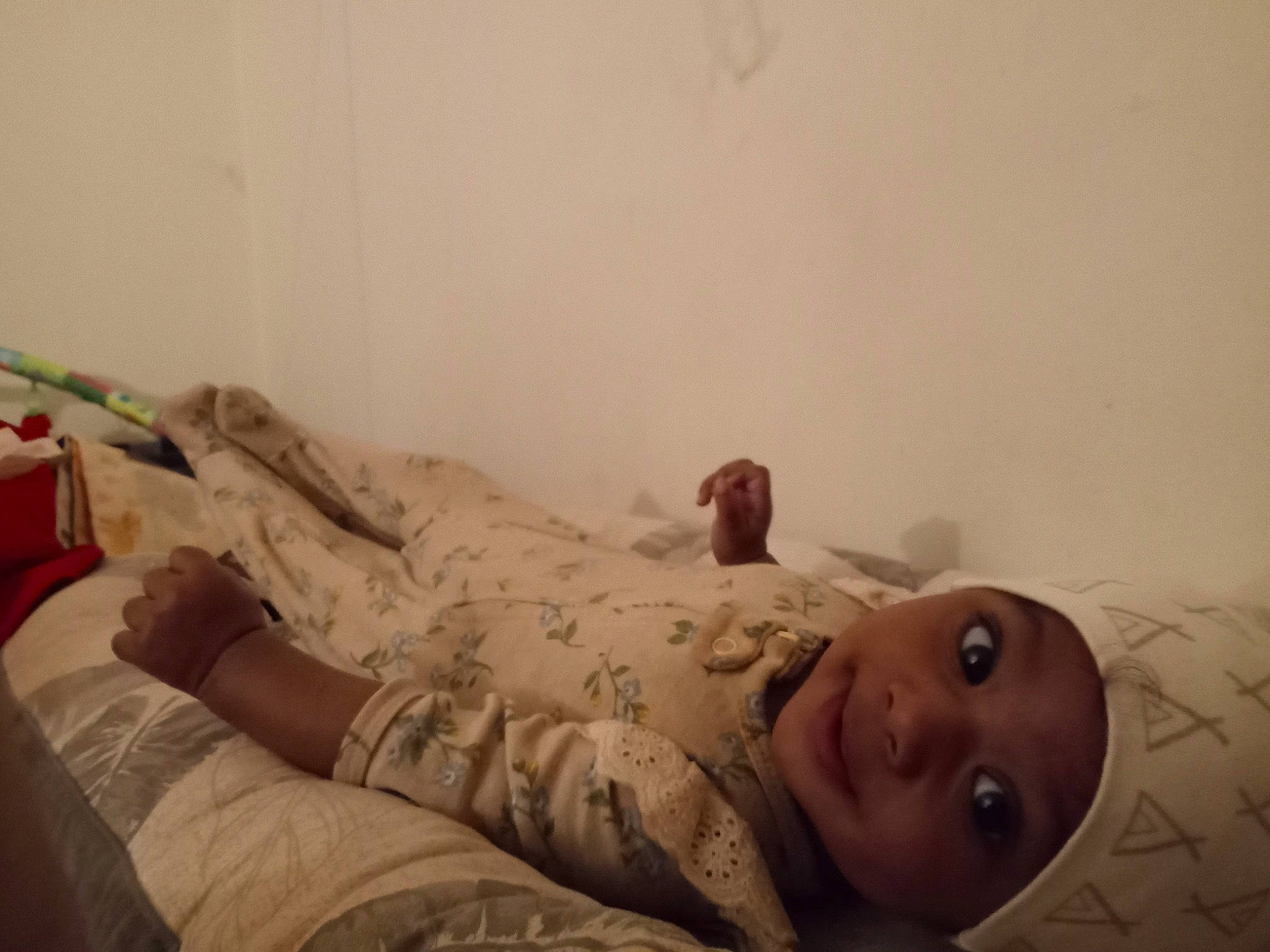 Kendra is registered to the contest to win money with this photo: abdomen, baby, bed, bed_sheet, bedding, bedroom, bedtime, child, comfort, flesh, floor, flooring, hardwood, headwear, human_leg, knee, linens, person, room, sitting