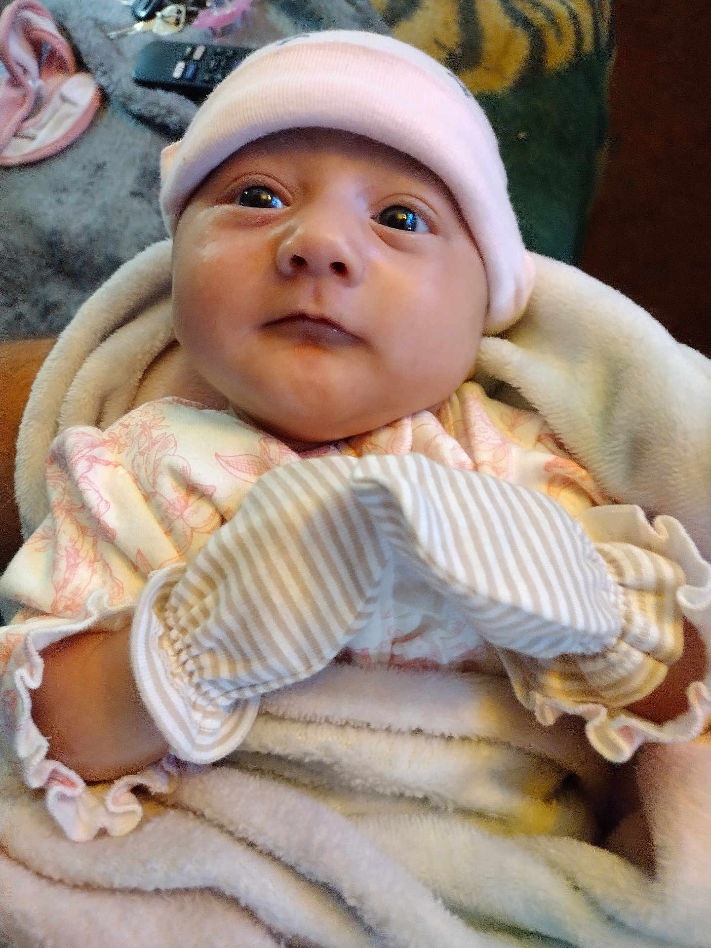 Amayah joined the competition — help win amazing prizes! baby, infant, blanket, mittens, hat, clothing, face, eyes, person, portrait, indoor, cozy, soft, cute, newborn, babywear, closeup, expression, child, warm