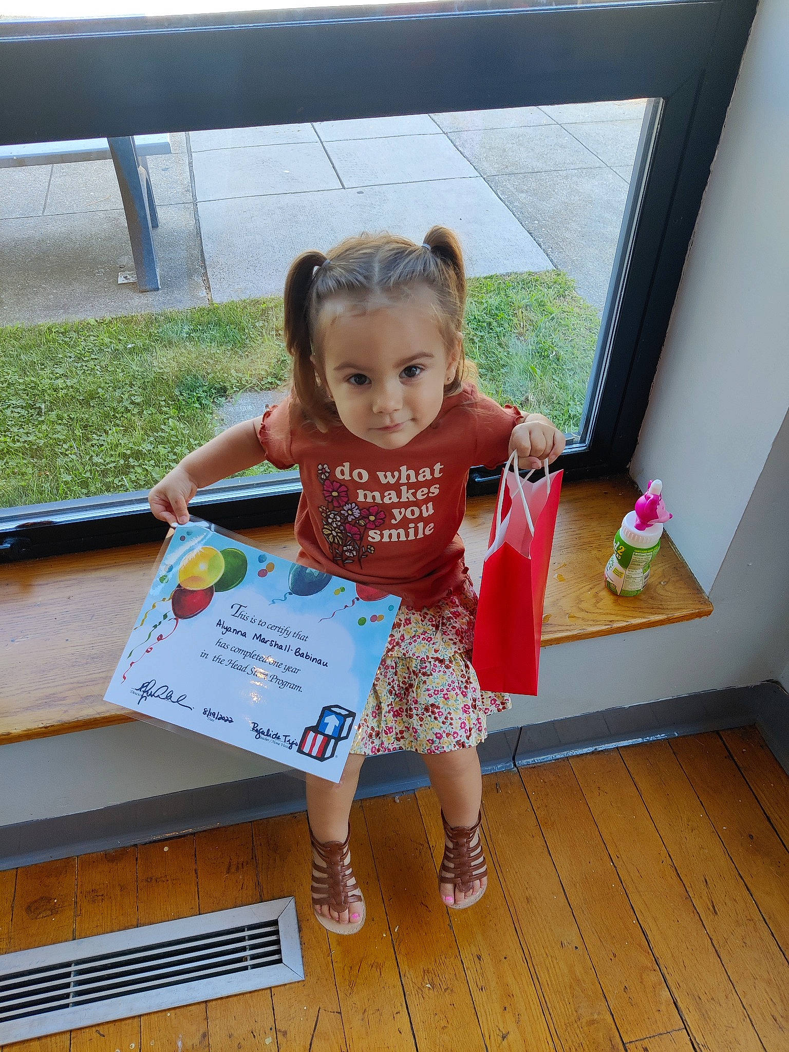 Alyanna is registered to the contest to win money with this photo: baby_toddler_clothing, child, flooring, fun, happy, human_leg, leisure, magenta, person, play, recreation, room, sandal, t_shirt, thigh, toddler, vacation, wood