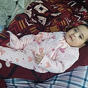 Gursehej joined the competition — help win amazing prizes! baby, blanket, child, cozy, cute, face, heart_pattern, indoor, infant, lying_down, onesie, person, pink_clothing, plaid_pants, red_blanket, resting, sleepwear, soft_texture, warm, young