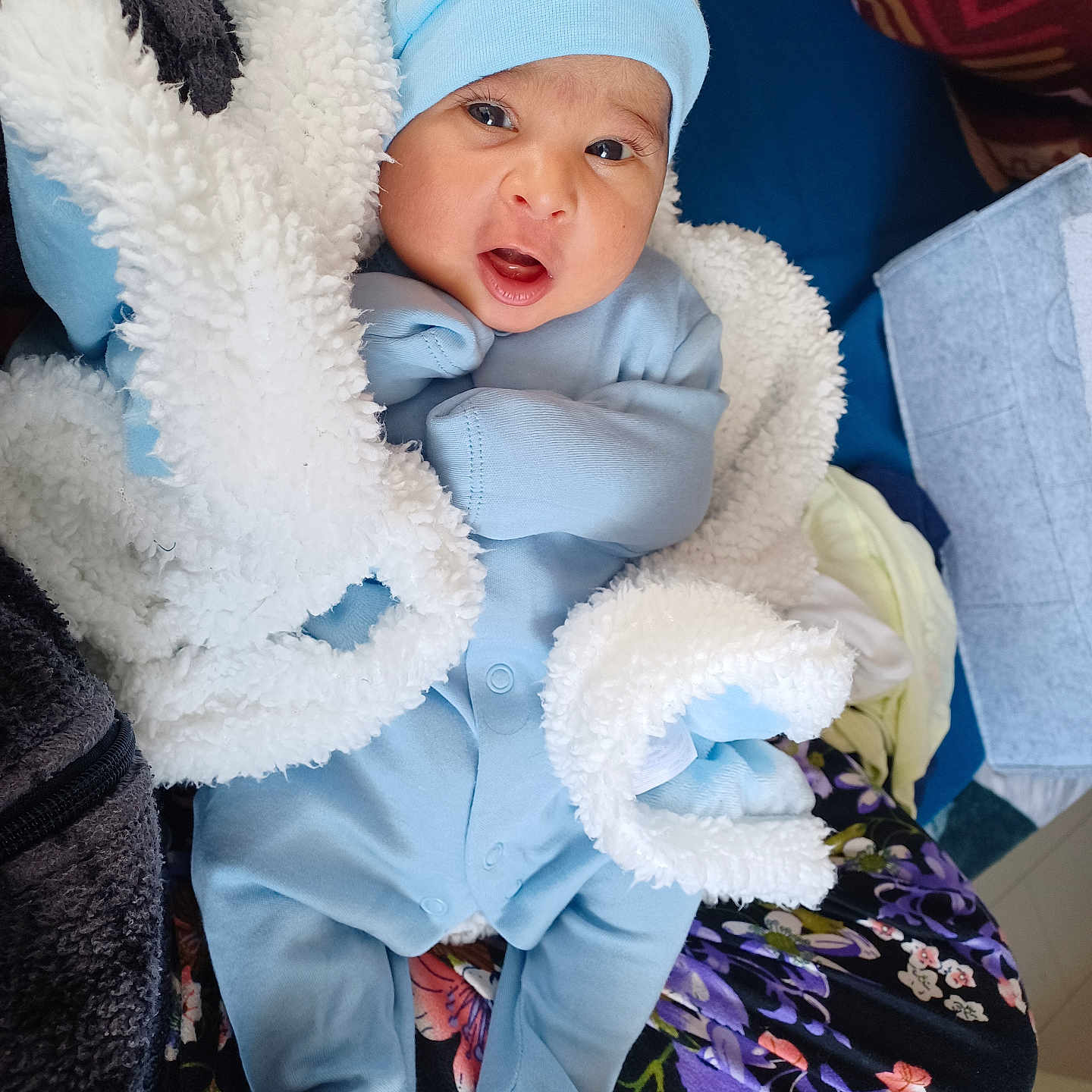 Gursehej is registered to the contest to win money with this photo: baby, blanket, blue_clothing, child, comfort, cozy, cute, expression, eyes, face, hat, indoor, infant, mouth, newborn, person, sleepwear, soft_texture, warm, wrapped