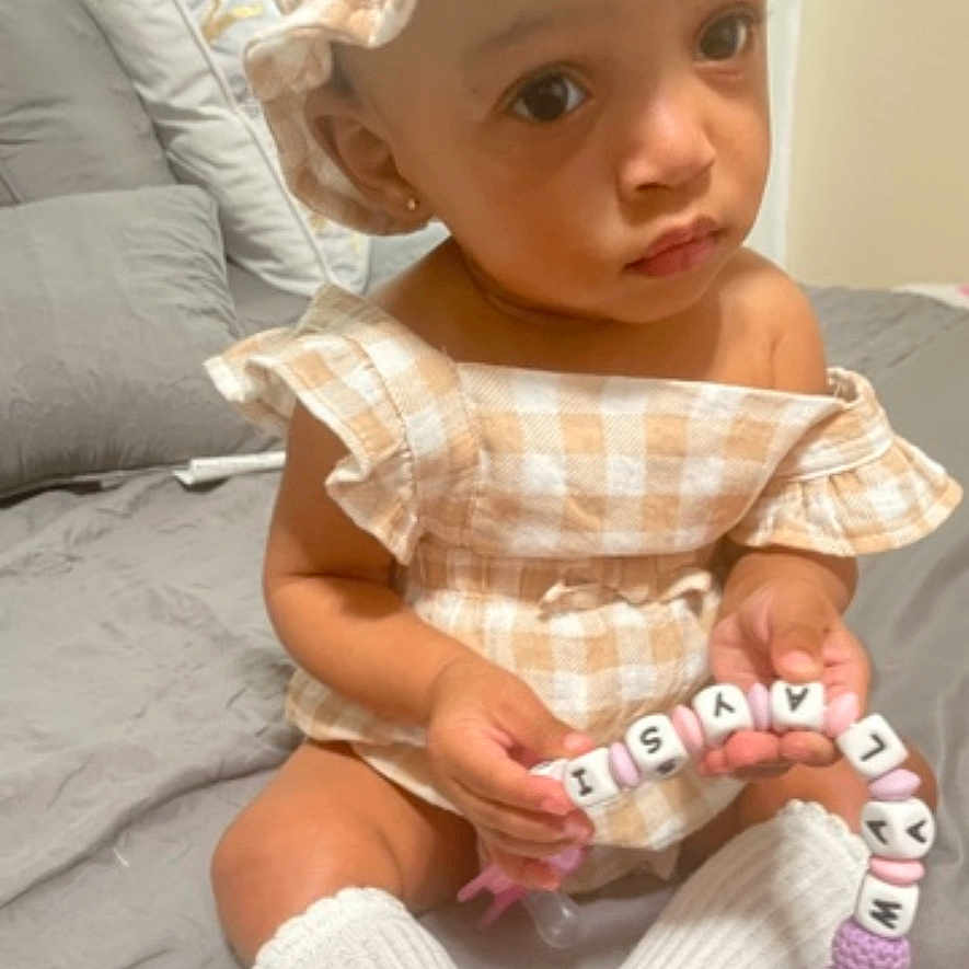 Malaysia is registered to the contest to win money with this photo: baby, bodypart, bonnet, clothing, couch, cushion, face, finger, furniture, hand, happy, hat, head, homedecor, newborn, person, photography, portrait, sitting, smile