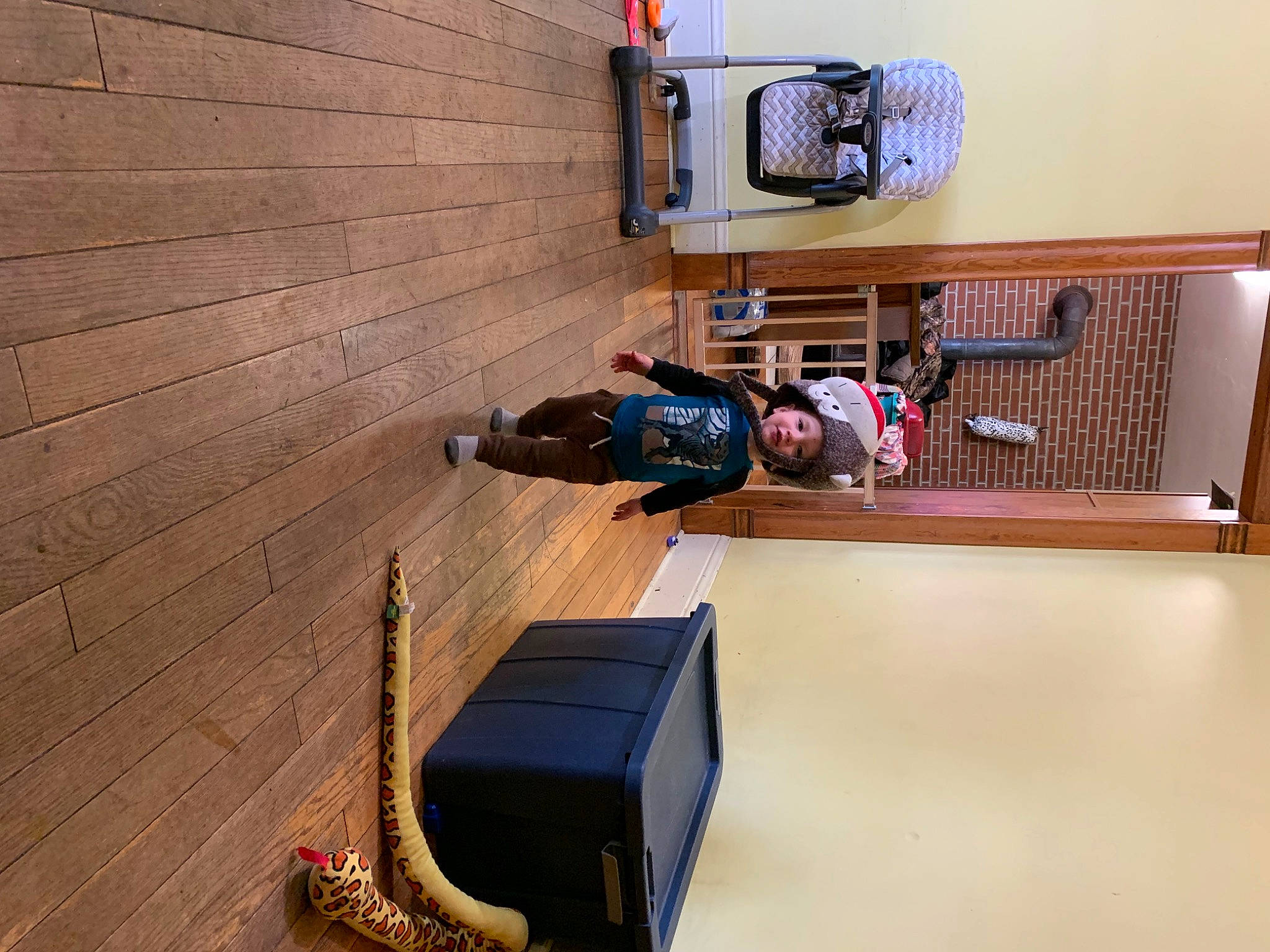 Odin is registered to the contest to win money with this photo: audio_equipment, brick, brickwork, electrical_wiring, floor, flooring, hardwood, headwear, house, laminate_flooring, machine, musical_instrument, person, plywood, room, siding, toddler, toy, varnish, wood