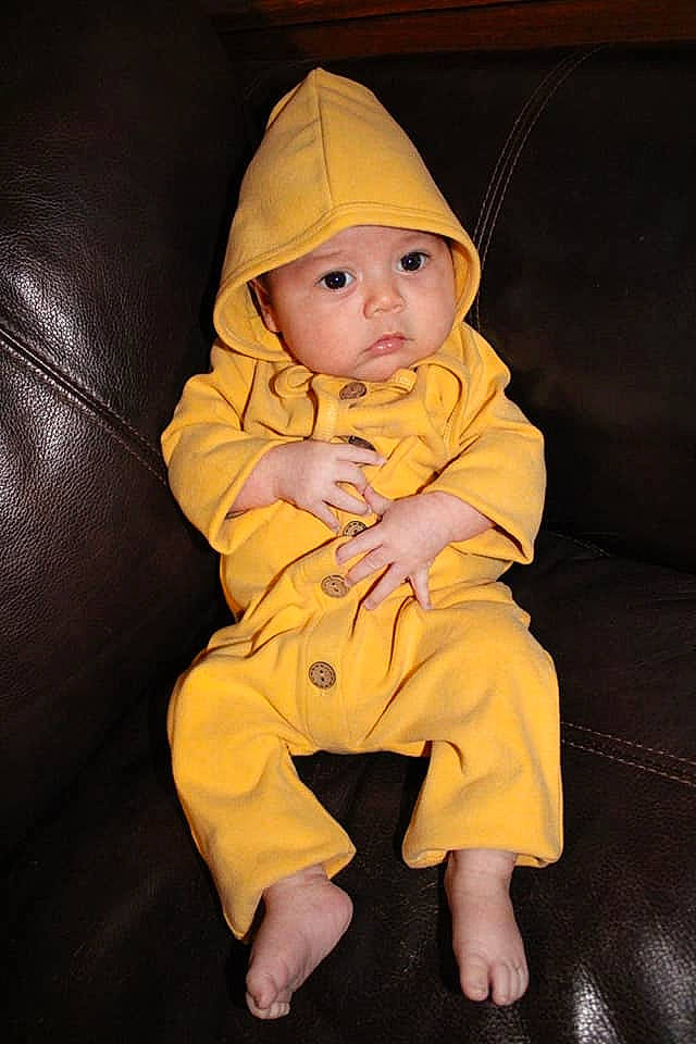 Gadiel is registered to the contest to win money with this photo: baby, baby_products, baby_toddler_clothing, cap, cheek, child, comfort, costume_hat, eye, fashion_accessory, flooring, head, headwear, human_body, iris, linens, person, room, sitting, sleeve