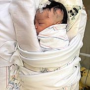 Paris joined the competition — help win amazing prizes! newborn, baby, hospital, blanket, swaddled, sleeping, face, head, medical_tape, panda_print, cloth, bed, person, infant, cute, soft, wrapped, healthcare, closeup, quiet