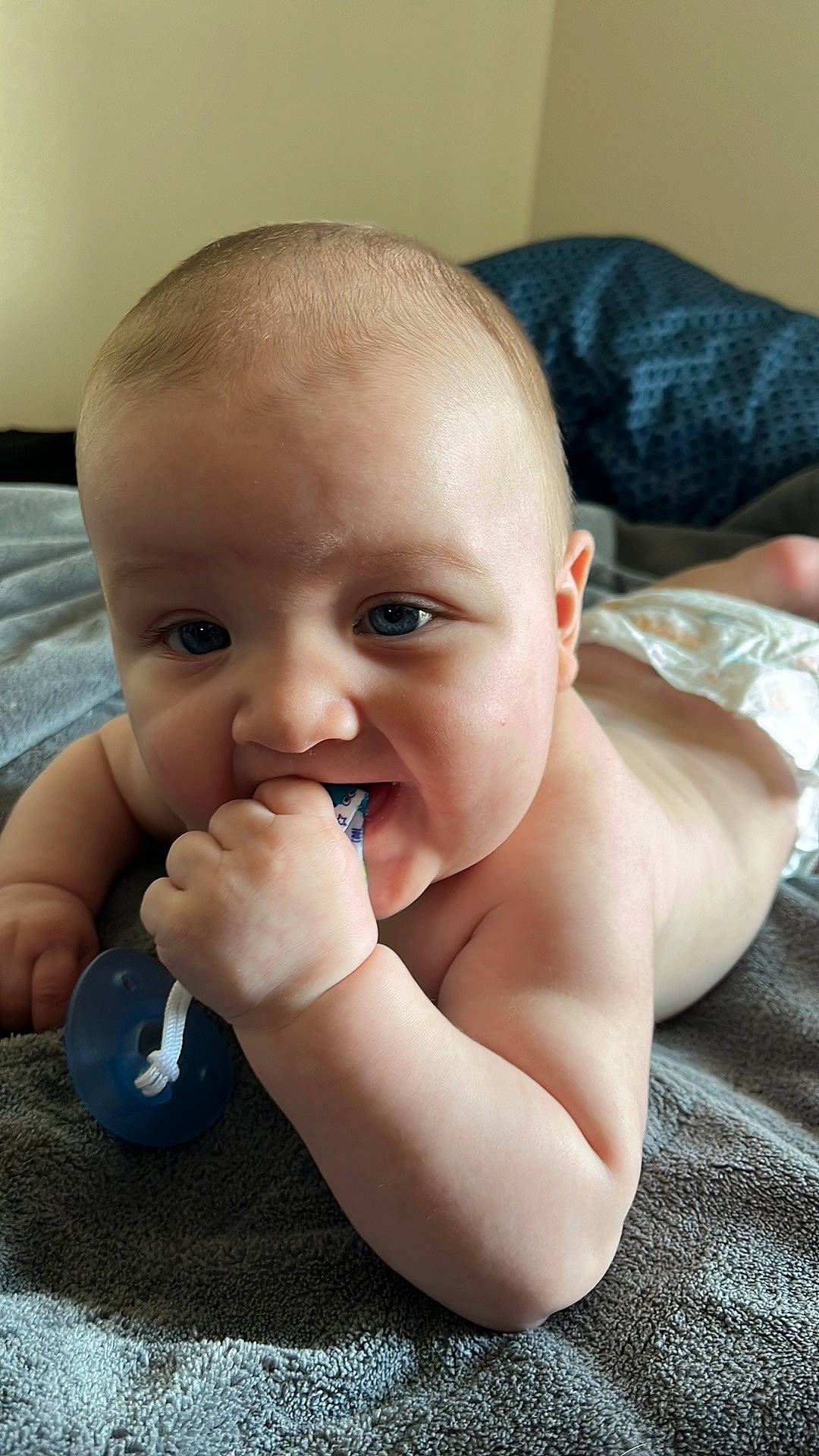 Elliot is registered to the contest to win money with this photo: baby_toddler_clothing, cheek, chin, ear, eye, eyebrow, face, finger, gesture, happy, head, human_body, iris, lip, mouth, neck, nose, person, skin, thumb