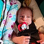 baby, infant, car_seat, pacifier, blanket, safety_harness, child, cute, indoors, soft_texture, clothing, person, newborn, hand, face, expression, comfort, seatbelt, closeup, toddler