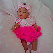 Alayzia joined the competition — help win amazing prizes! baby, infant, pink, tutu, headband, cushion, heart_pattern, socks, cute, child, portrait, indoor, soft, blanket, clothing, smile, face, person, cozy, relaxing