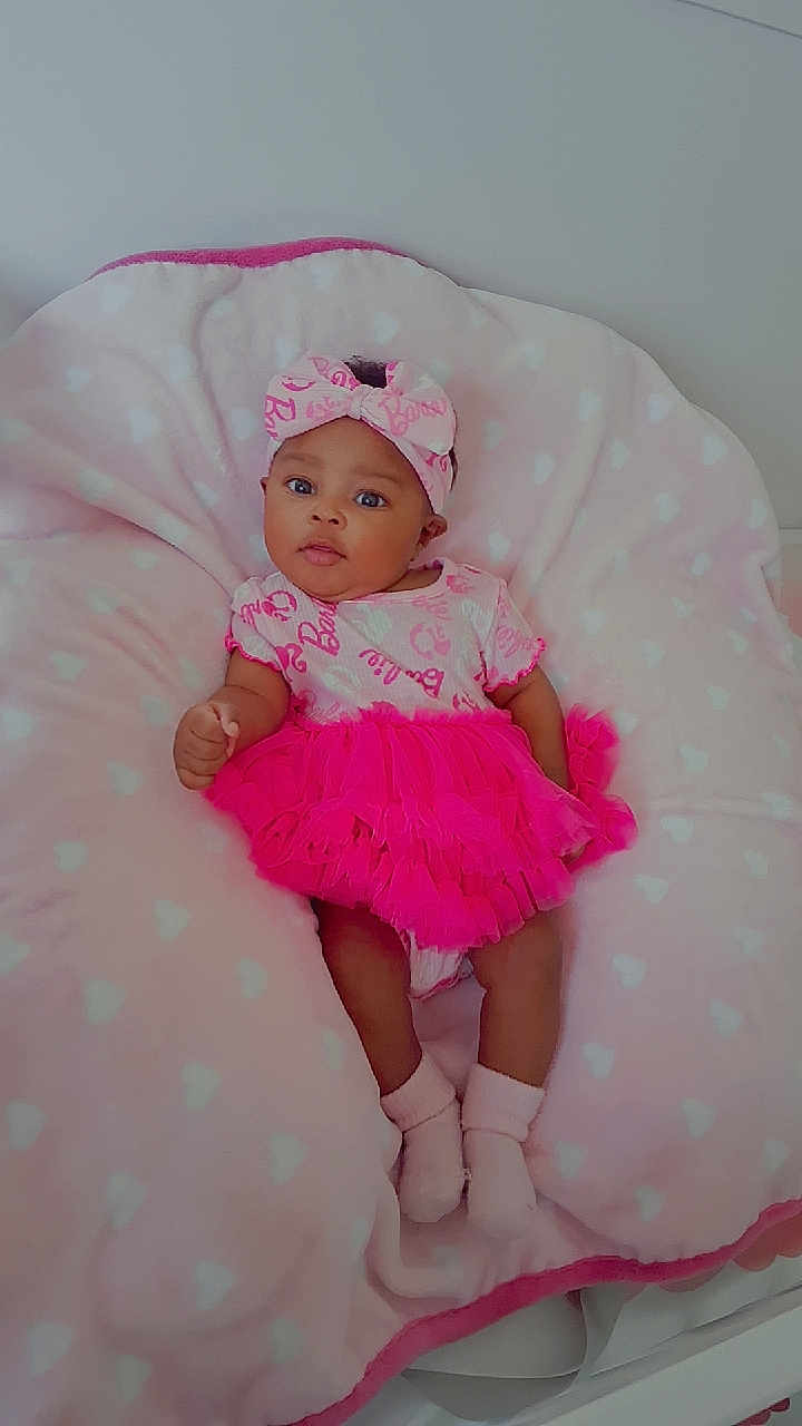 Alayzia joined the competition — help win amazing prizes! baby, infant, pink, tutu, headband, cushion, heart_pattern, socks, cute, child, portrait, indoor, soft, blanket, clothing, smile, face, person, cozy, relaxing