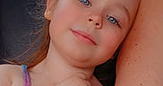 Luna is registered to the contest to win money with this photo: child, girl, blue_eyes, tattoo, arm, car_seat, seat, backseat, casual, portrait, relaxed, summer_clothing, tank_top, hair, person, skin, expression, comfort, inside, vehicle