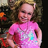 child, girl, smiling, pink_shirt, glasses, curly_hair, necklace, bracelet, barbie, portrait, indoor, fashion, jewelry, accessories, happy, posing, colorful, decor, bag, casual