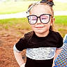 Luna joined the competition — help win amazing prizes! child, girl, glasses, hair_bows, black_dress, silver_stripes, outdoor, park, blue_bench, confident, pose, smile, closed_eyes, reflection, young, cute, fashion, accessory, happy, person