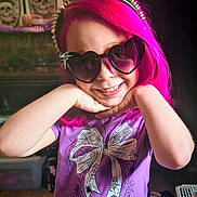 Luna joined the competition — help win amazing prizes! child, pink_hair, heart_shaped_sunglasses, spiked_headband, purple_shirt, spiderweb_design, smiling, posing, indoor, young_girl, portrait, fashion_accessory, cute, happy, colorful, glasses, headwear, fun, casual_clothing, person