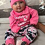 baby, child, comfortable, couch, cozy, cute, floral_pants, footwear, hand, happy, hat, home, indoor, infant, person, pink_clothing, portrait, sitting, smiling, soft_toys