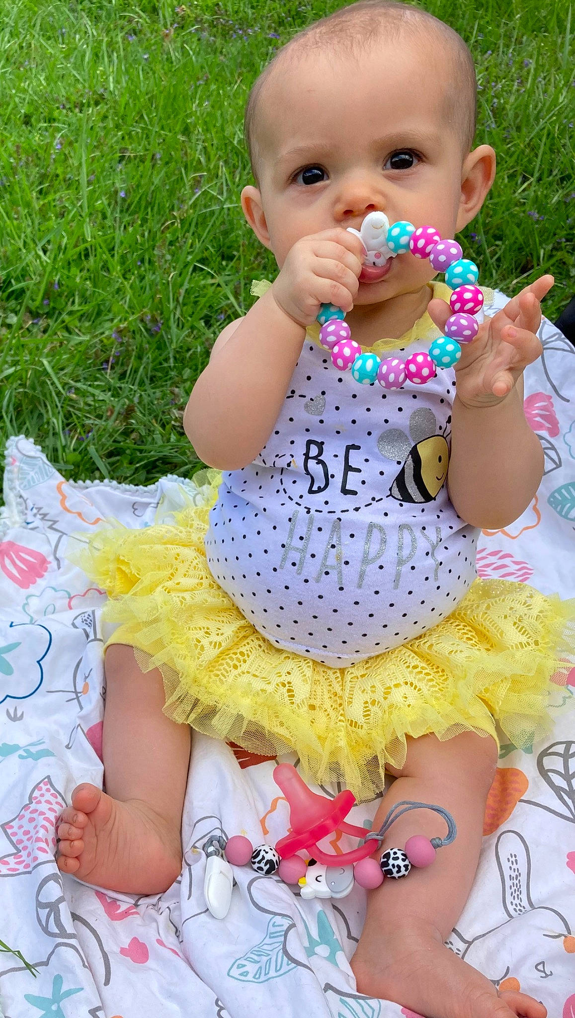 Madelyn is registered to the contest to win money with this photo: baby_products, baby_toddler_clothing, child, dress, event, fun, grass, green, happy, leisure, pattern, person, photograph, pink, plant, sitting, spring, summer, thigh, toddler