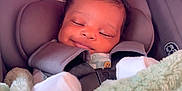 Makenzie is registered to the contest to win money with this photo: baby, infant, car_seat, blanket, bow, smile, sleeping, child, cute, soft_texture, cozy, warm, white_socks, head_support, clothing, indoor, portrait, baby_accessory, seatbelt, peaceful