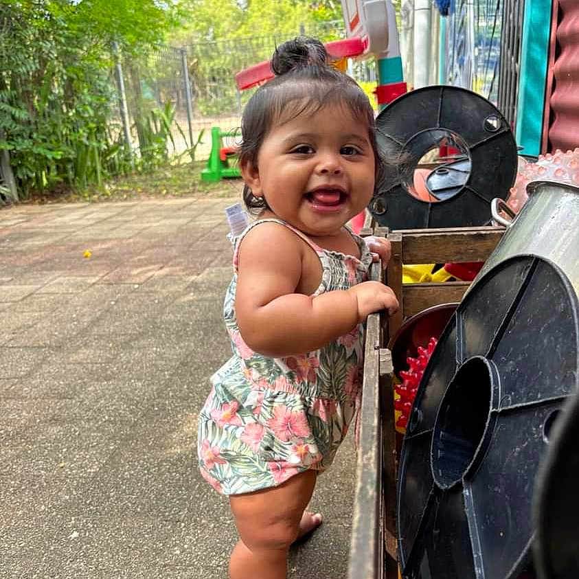 Valkyrie is registered to the contest to win money with this photo: architecture, baby, building, city, clothing, dress, face, happy, head, outdoors, person, photography, plant, portrait, pottedplant, road, shelter, street, summer, urban