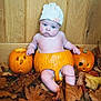 Arthur is registered to the contest to win money with this photo: baby, pumpkin, carved_pumpkin, hat, autumn_leaves, fall, child, halloween, indoor, wood_paneling, cute, chubby, diaper, orange, seasonal, holiday, face, sitting, festive, decoration