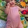 Zayleigh is registered to the contest to win money with this photo: baby, infant, smiling, play_mat, toy, pink_romper, lying_down, cute, child, colorful, owl_pattern, hand, face, happy, indoors, soft_toys, legs, expression, background, playtime