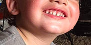 Rebel joined the competition — help win amazing prizes! child, smiling, face, curly_hair, teeth, gray_shirt, indoor, carpet, happy, close_up, person, cute, playful, young, toddler, casual, portrait, candid, cheeky, light