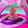 Ellia is registered to the contest to win money with this photo: baby, infant, child, float, inflatable, pool, water, canopy, pink, purple, swimwear, toy, mesh, seating_ring, summer, outdoors, toddler, curious_expression, hand, face