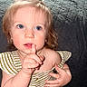 Ellia joined the competition — help win amazing prizes! baby, blue_eyes, child, close_up, curly_hair, cute, expression, face, finger_on_lips, green_bow, hand_gesture, indoor, innocent, looking_up, person, portrait, soft_lighting, striped_clothing, toddler, young_child