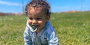Kays participe au concours pour gagner de l'argent avec cette photo : baby, blue_sky, child, clouds, crawling, curly_hair, daylight, flower, grass, greenery, happy, hoodie, nature, outdoor, pacifier, person, play, smiling, sunny, toddler