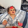 Kays participe au concours pour gagner de l'argent avec cette photo : baby, bed, box, child, curiosity, curly_hair, cute, expression, face, hands, home, indoor, onesie, person, petals, playful, red_petals, striped_bedspread, toddler, young_child