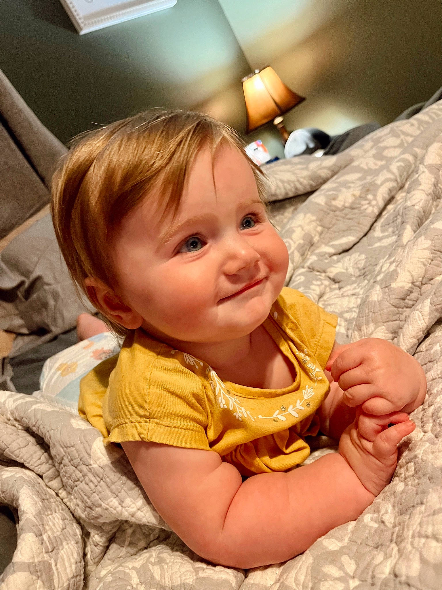 Wrenley is registered to the contest to win money with this photo: baby, baby_toddler_clothing, blond, cheek, child, comfort, face, fun, gesture, hairstyle, happy, head, iris, joy, mouth, nose, person, sitting, skin, sleeve