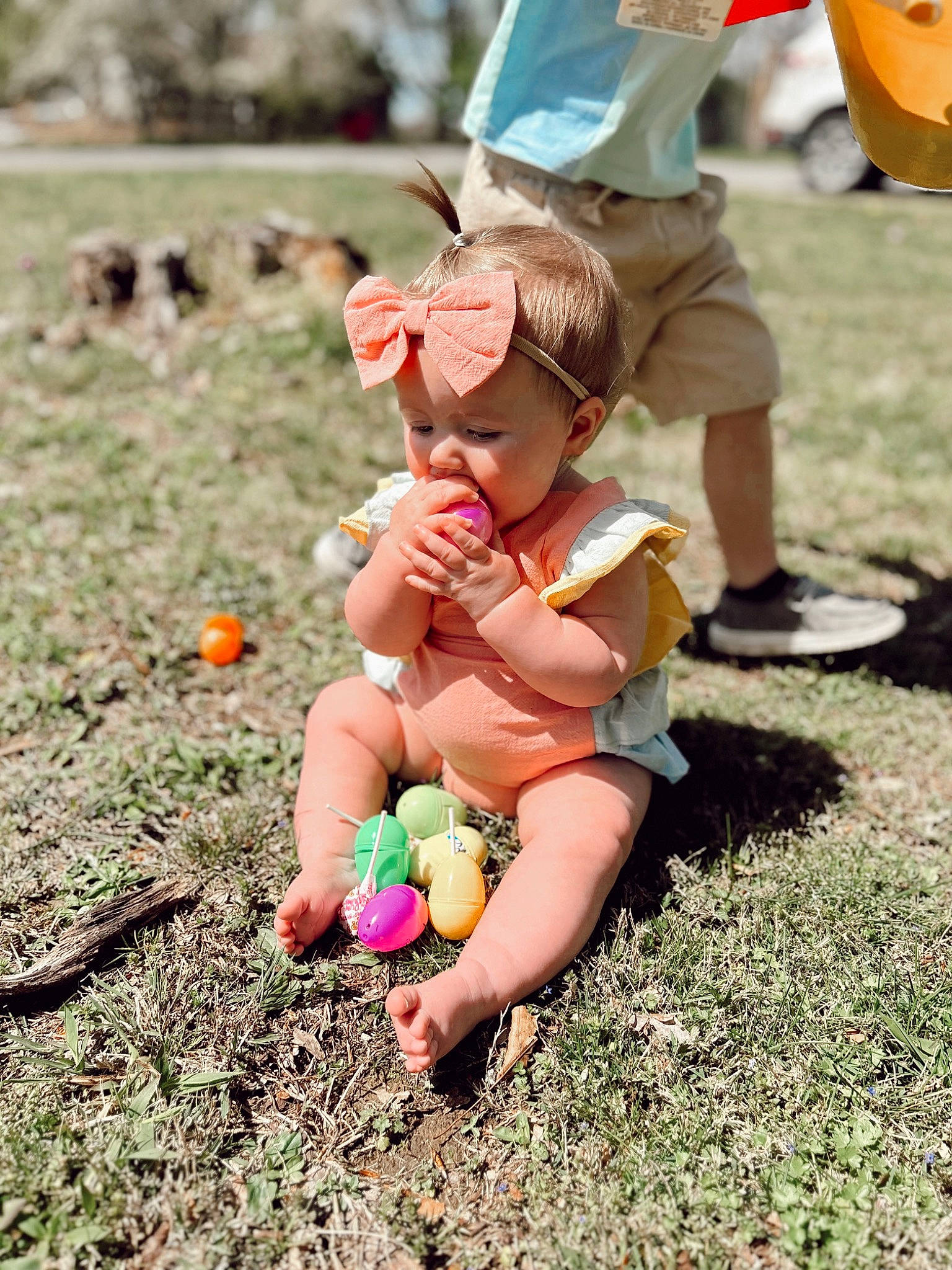 Wrenley is registered to the contest to win money with this photo: baseball_cap, cap, fun, grass, happy, hat, human_leg, leg, leisure, people_in_nature, person, plant, recreation, sandal, shoe, shorts, sneakers, sun_hat, thigh, toddler