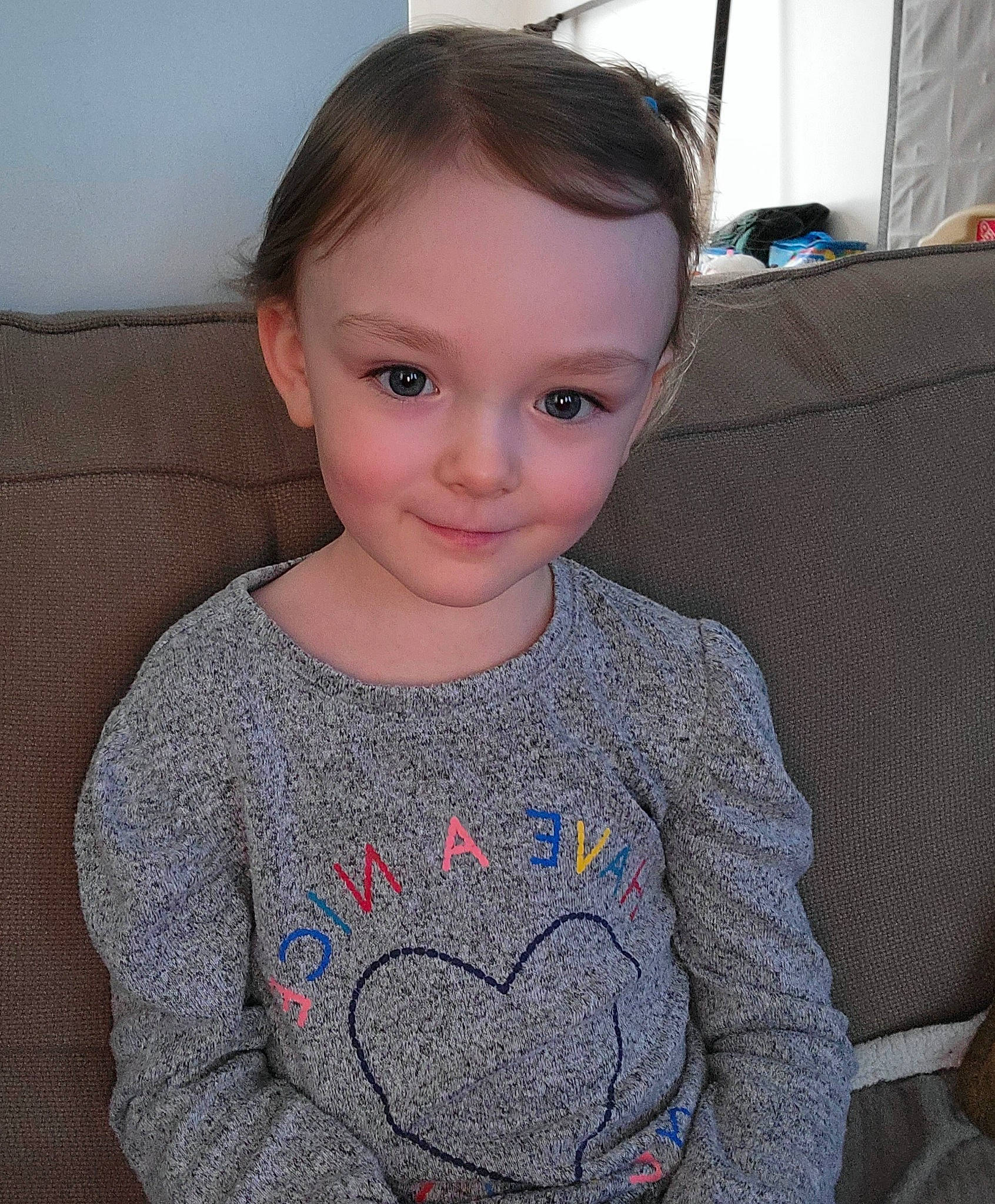 Kira is registered to the contest to win money with this photo: baby_toddler_clothing, cheek, cool, eye, finger, forehead, grey, hair, iris, joy, lip, mammal, neck, nose, outerwear, person, skin, sleeve, smile, t_shirt